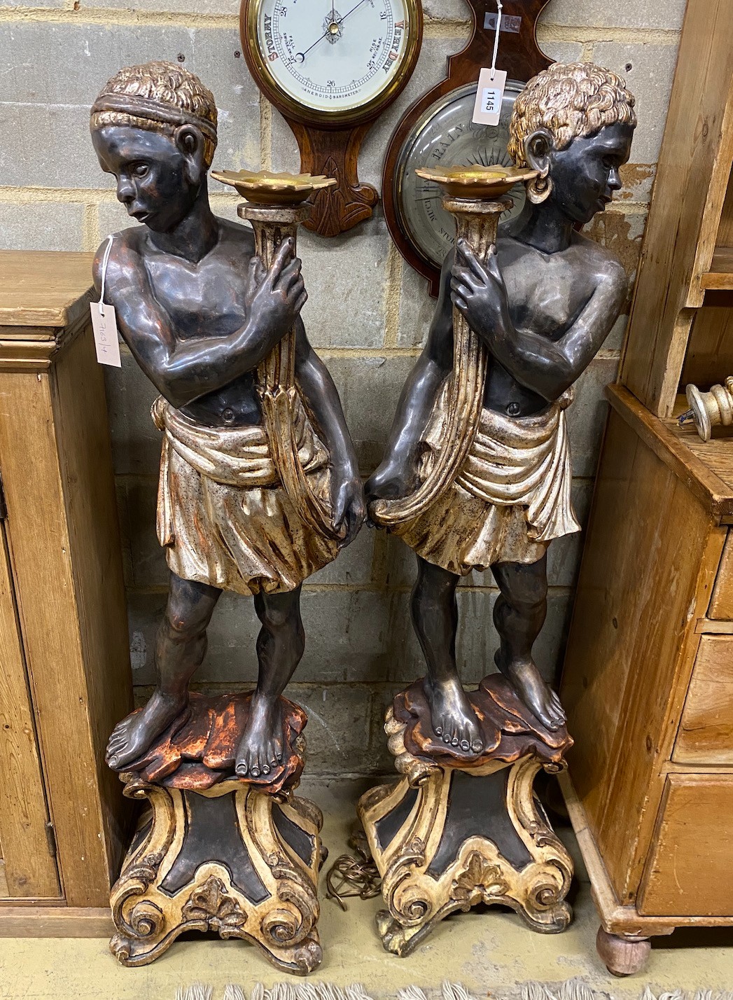 A pair of Italian carved wood Blackamoor torcheres, with a pair of six branch lights now detached, height 133cm